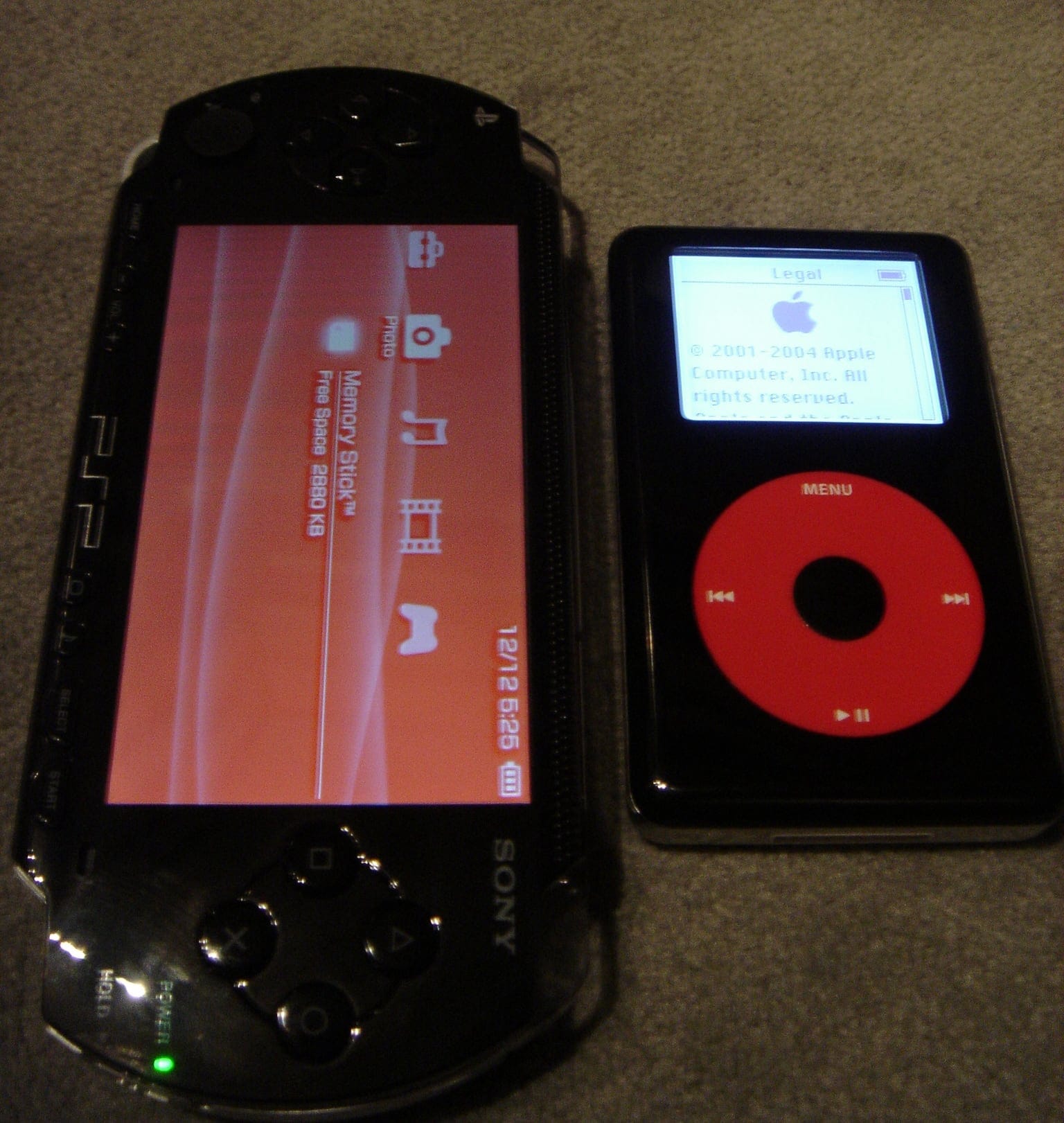 A photo of a PlayStation Portable and iPod side-by-side, showing that the PSP's screen is the same size as the whole body of the iPod.