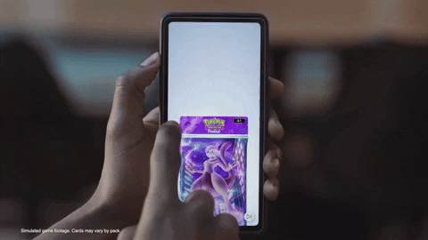 Person swipes on a smartphone screen to open a packet of Pokémon cards.