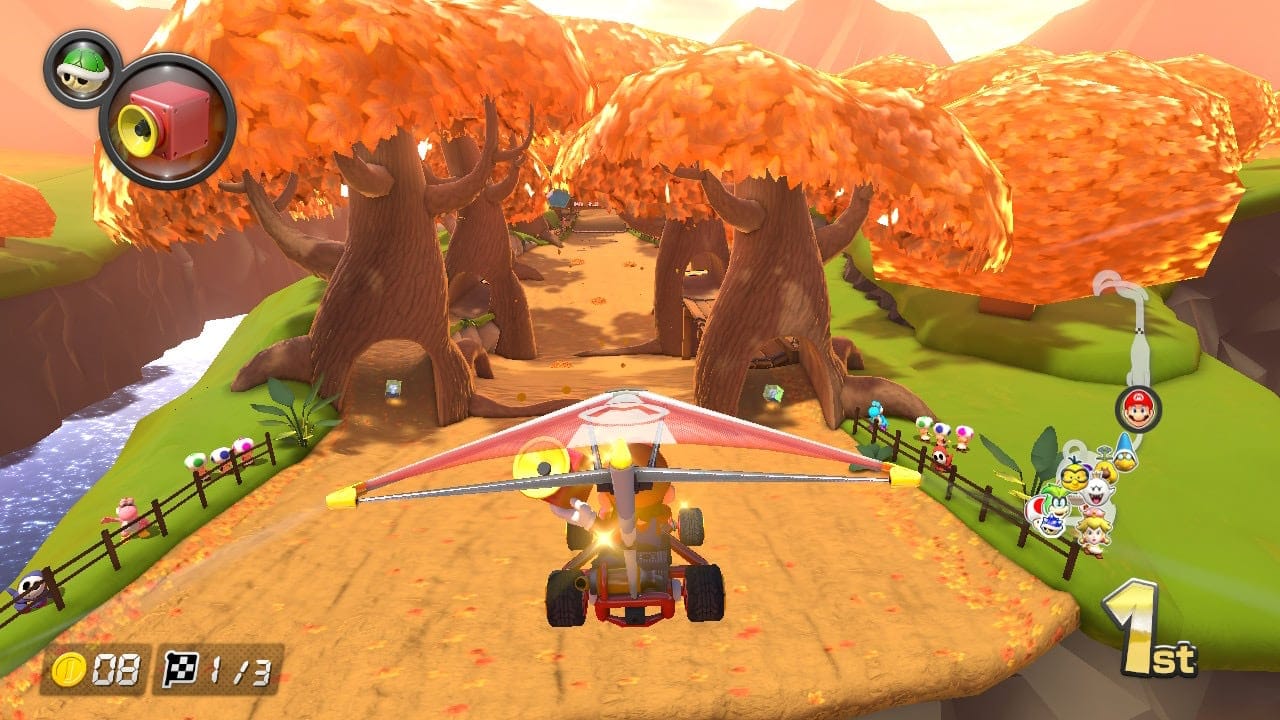 A screenshot from the Nintendo Switch game Mario Kart 8 Deluxe showing Mario racing on Maple Treeway.