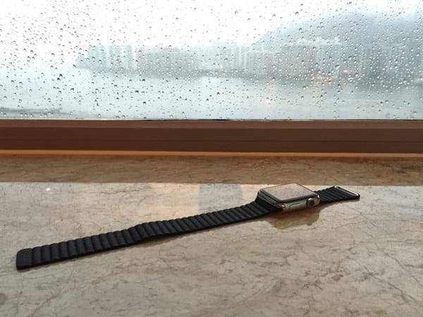 A photo of the original Apple Watch sitting on a windowsill.